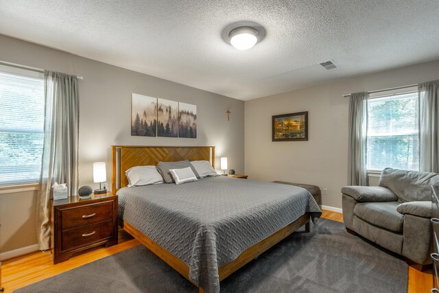 821 Ravine Rd, Signal Mountain, TN 37377 - bedroom with wood finished floors, a textured ceiling, and baseboards