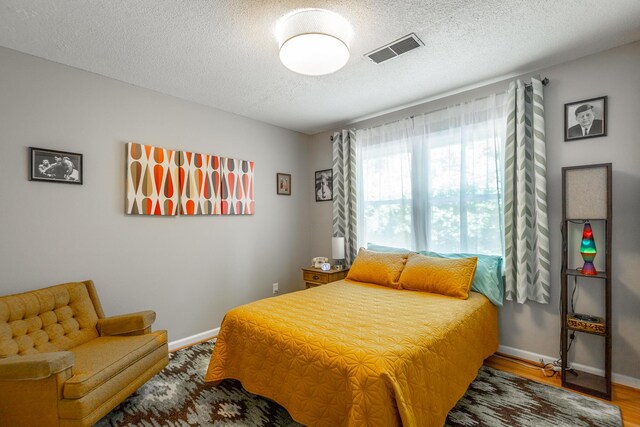821 Ravine Rd, Signal Mountain, TN 37377 - bedroom with a textured ceiling, baseboards, and wood finished floors