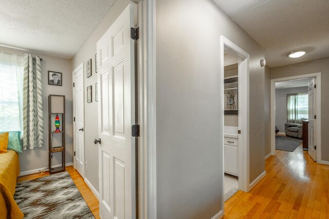 821 Ravine Rd, Signal Mountain, TN 37377 - corridor with a textured ceiling, light wood finished floors, and baseboards