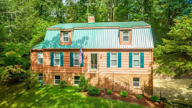 821 Ravine Rd, Signal Mountain, TN 37377 - view of front facade featuring a chimney, metal roof, a front lawn, stairway, and brick siding