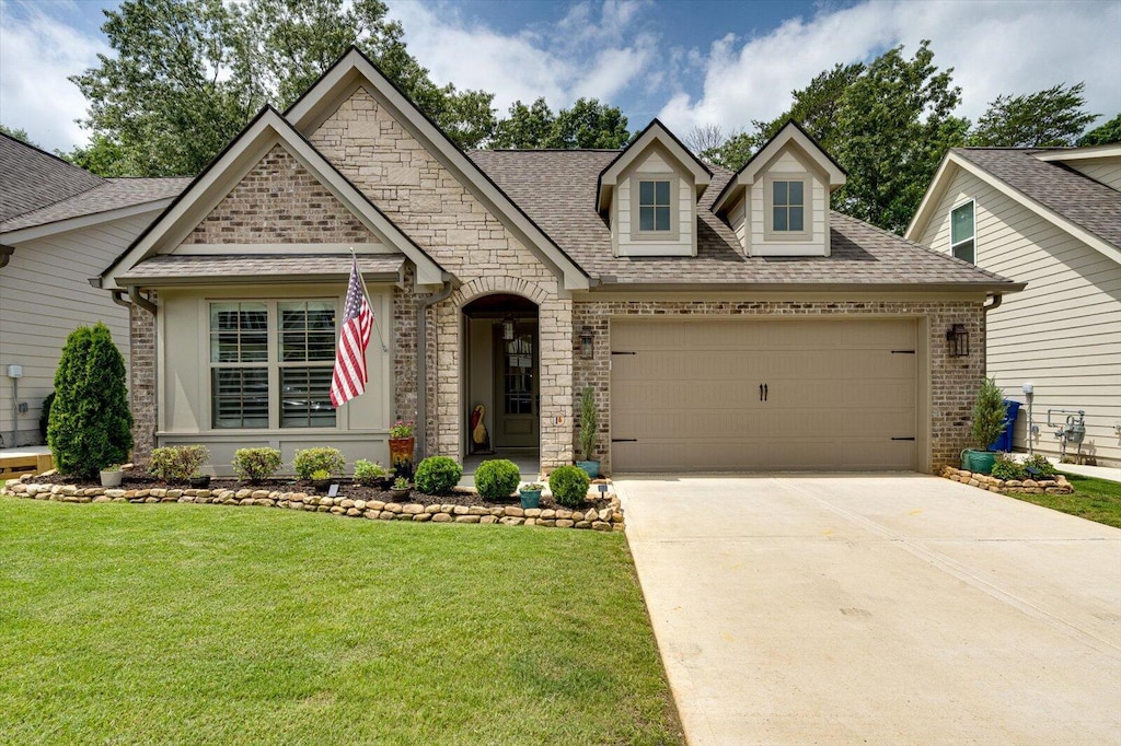 1800 Emmeline Way, Hixson, TN 37343 - view of front facade featuring brick siding, an attached garage, a front lawn, roof with shingles, and concrete driveway
