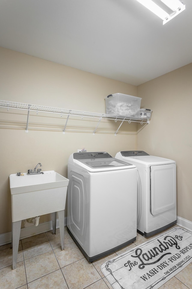 7531 Nightfall Cir, Ooltewah, TN 37363 - laundry area with independent washer and dryer, light tile patterned floors, and baseboards