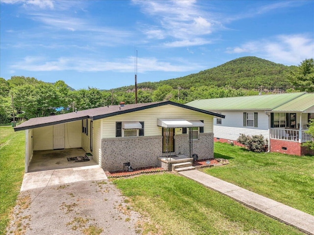 1806 Wayne Ave, South Pittsburg, TN 37380 - view of front of house featuring driveway, a carport, a front yard, a mountain view, and crawl space