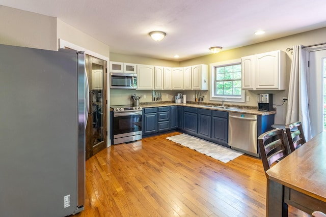 2217 Sr 399, Palmer, TN 37365 - kitchen featuring appliances with stainless steel finishes, a sink, white cabinetry, light wood-style floors, and recessed lighting