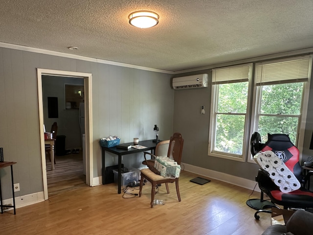 office area with crown molding, wood finished floors, a wall mounted AC, a textured ceiling, and baseboards