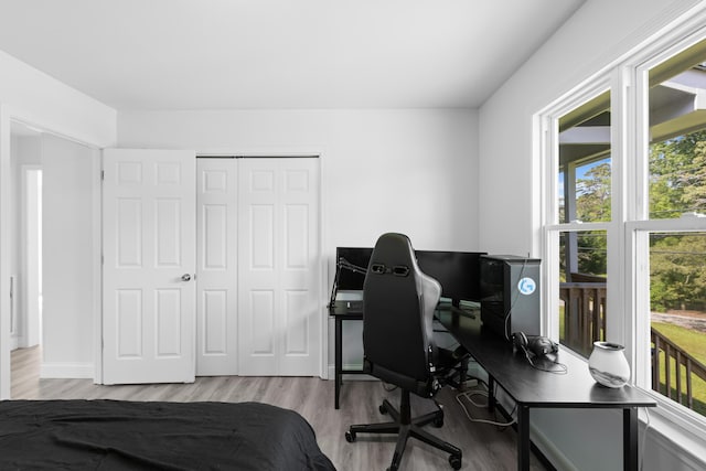 9503 Weidner Ln, Ooltewah, TN 37363 - bedroom with wood finished floors, a desk, a closet, and baseboards