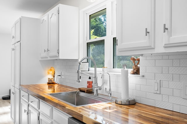9503 Weidner Ln, Ooltewah, TN 37363 - kitchen with a sink, butcher block countertops, tasteful backsplash, and white cabinetry