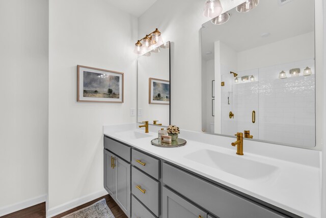 135 Peerless Ave Unit 120, Chattanooga, TN 37405 - full bathroom with double vanity, a shower stall, wood finished floors, and baseboards