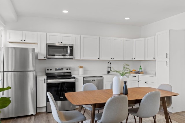 2806 N Chamberlain Ave, Chattanooga, TN 37406 - kitchen with stainless steel appliances, a sink, light countertops, light wood-type flooring, and recessed lighting