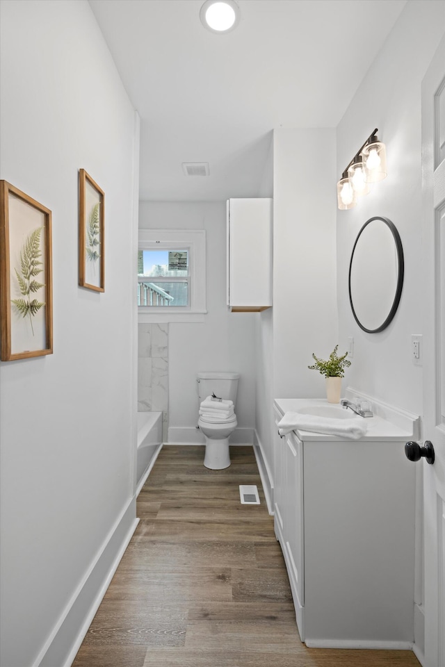 2806 N Chamberlain Ave, Chattanooga, TN 37406 - bathroom with vanity, wood finished floors, and a tub to relax in