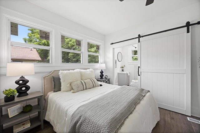 2806 N Chamberlain Ave, Chattanooga, TN 37406 - bedroom featuring a barn door, dark wood-style floors, multiple windows, and ceiling fan