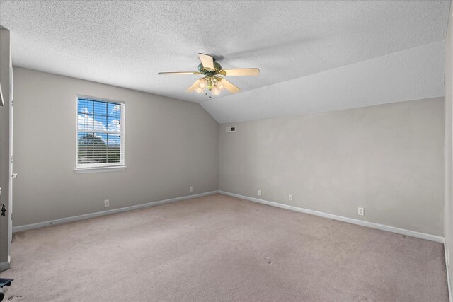 8719 Glenaire Dr, Chattanooga, TN 37416 - unfurnished room featuring a ceiling fan, carpet floors, baseboards, lofted ceiling, and a textured ceiling