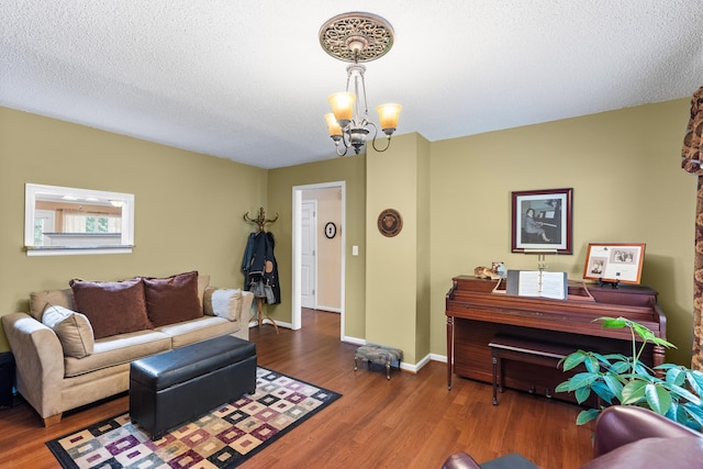 8719 Glenaire Dr, Chattanooga, TN 37416 - living room with a chandelier, wood finished floors, a textured ceiling, and baseboards