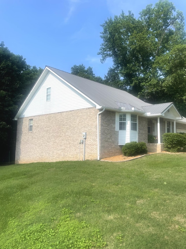 8719 Glenaire Dr, Chattanooga, TN 37416 - view of side of property with a lawn, a metal roof, and brick siding