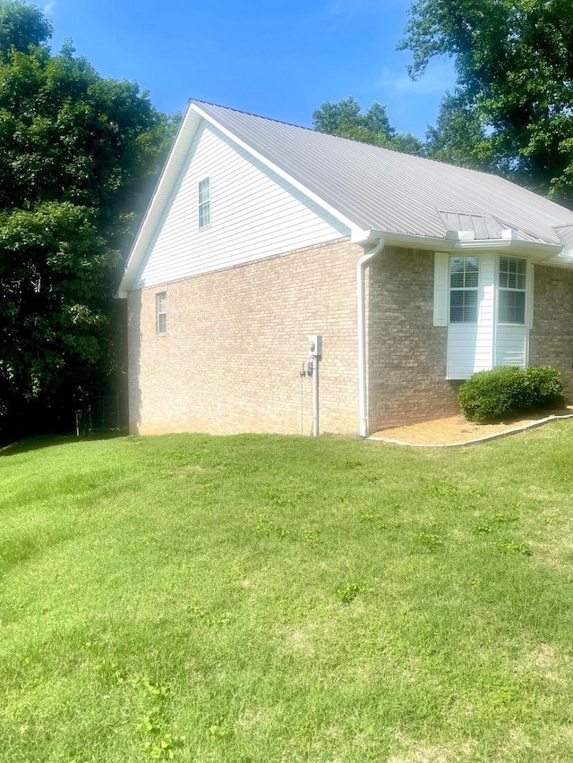 8719 Glenaire Dr, Chattanooga, TN 37416 - view of side of home with a yard, brick siding, and a metal roof