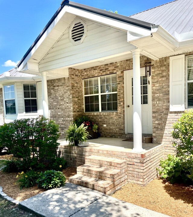 8719 Glenaire Dr, Chattanooga, TN 37416 - property entrance with a porch and brick siding