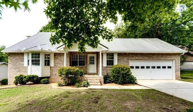 8719 Glenaire Dr, Chattanooga, TN 37416 - ranch-style home featuring concrete driveway, an attached garage, a metal roof, and a front lawn