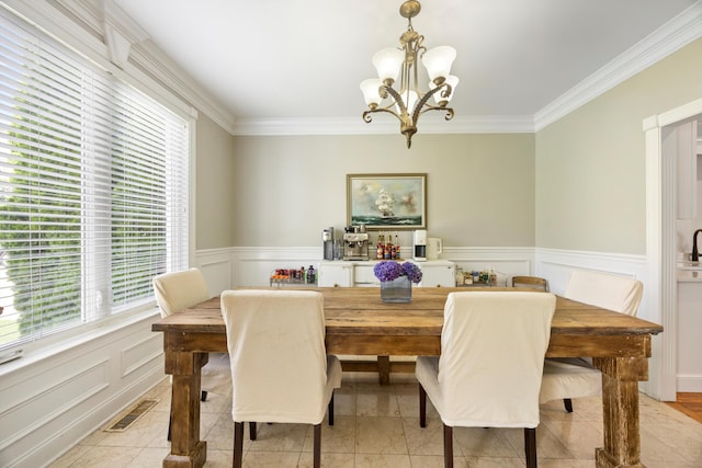 649 Wisley Way, Ringgold, GA 30736 - dining space with plenty of natural light, a chandelier, ornamental molding, a wainscoted wall, and a decorative wall