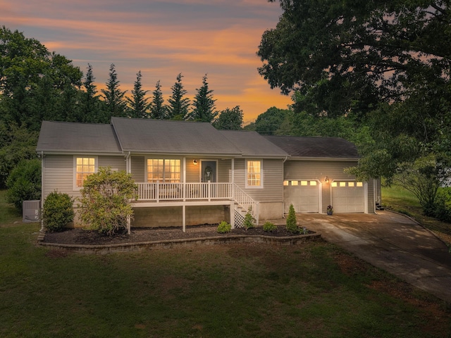 6504 Ramsey Rd, Harrison, TN 37341 - ranch-style home with a porch, a garage, a front yard, concrete driveway, and cooling unit
