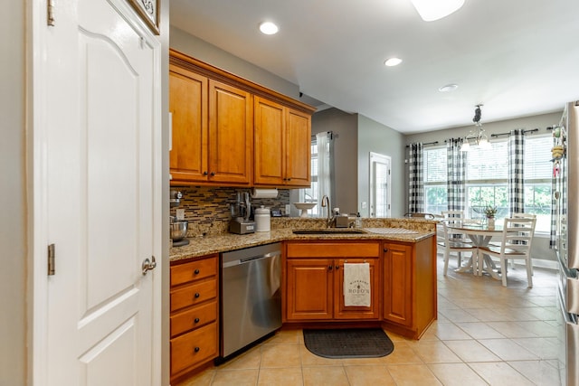 9923 Sims Harris Rd, Ooltewah, TN 37363 - kitchen featuring appliances with stainless steel finishes, a sink, a peninsula, brown cabinets, and light tile patterned flooring