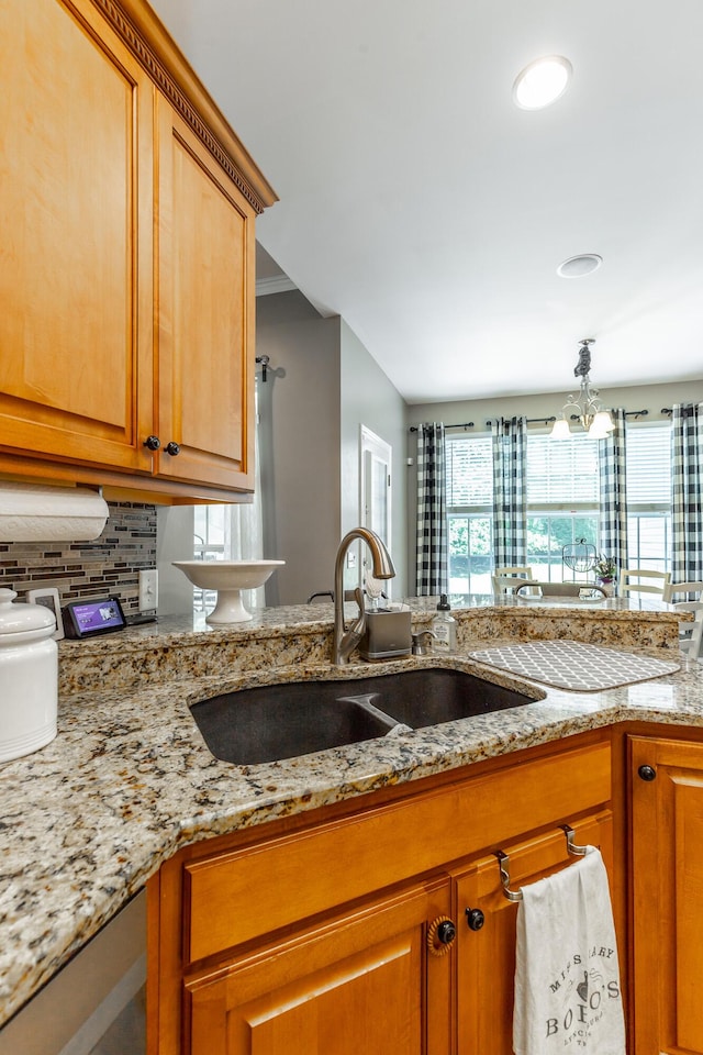 9923 Sims Harris Rd, Ooltewah, TN 37363 - kitchen featuring a sink, backsplash, light stone counters, brown cabinets, and recessed lighting