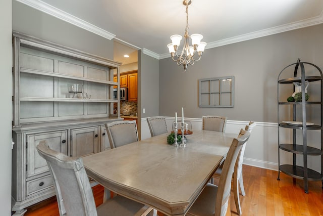 9923 Sims Harris Rd, Ooltewah, TN 37363 - dining space featuring crown molding, a chandelier, and wood finished floors