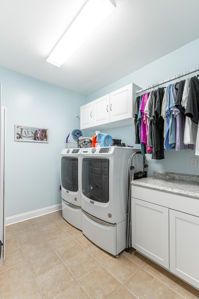 9923 Sims Harris Rd, Ooltewah, TN 37363 - washroom featuring washing machine and dryer, cabinet space, light tile patterned floors, and baseboards