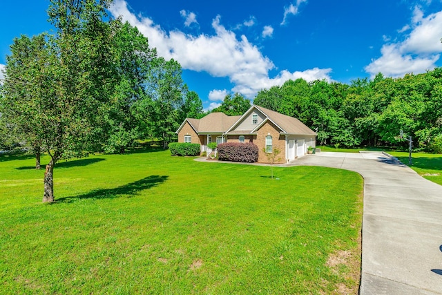 9923 Sims Harris Rd, Ooltewah, TN 37363 - view of front facade featuring driveway, a front yard, an attached garage, and brick siding