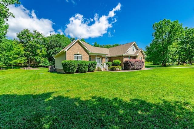 9923 Sims Harris Rd, Ooltewah, TN 37363 - ranch-style home featuring a front lawn and brick siding