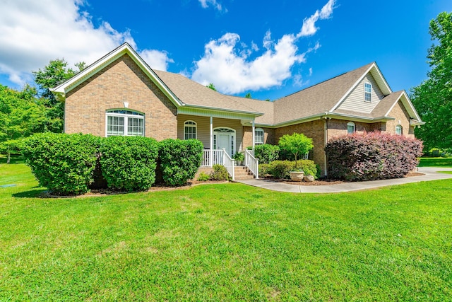 9923 Sims Harris Rd, Ooltewah, TN 37363 - view of front facade featuring brick siding, a porch, a front lawn, and roof with shingles