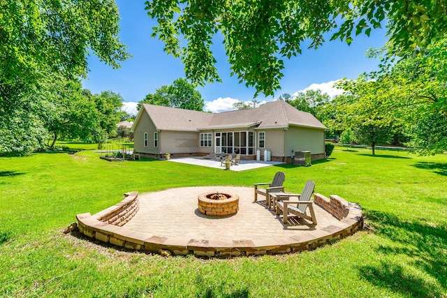 9923 Sims Harris Rd, Ooltewah, TN 37363 - rear view of house featuring an outdoor fire pit, a patio, a lawn, and a sunroom