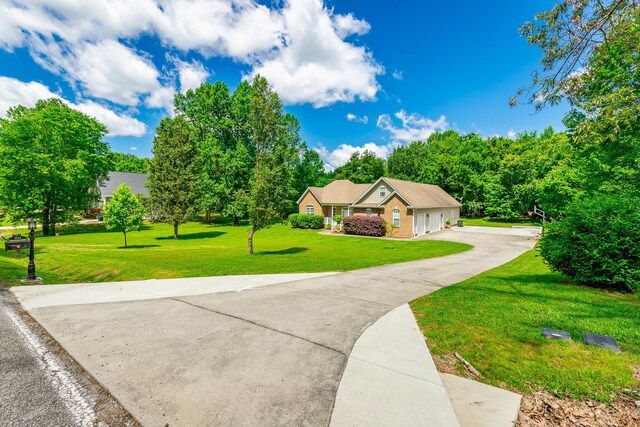 9923 Sims Harris Rd, Ooltewah, TN 37363 - view of front of property featuring a front yard, driveway, and a garage