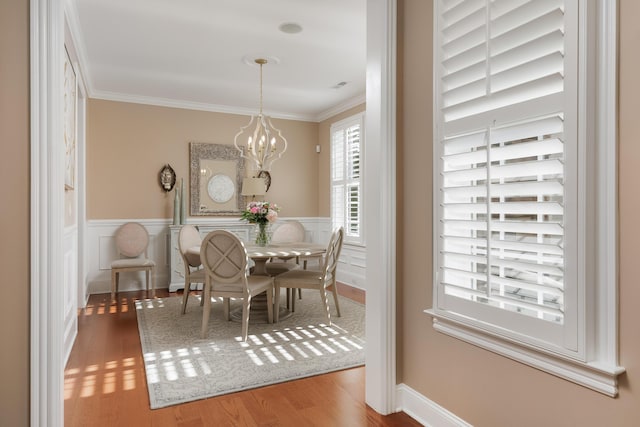 2027 Holden Farm Pl Unit 622, Ooltewah, TN 37363 - dining room with crown molding, wood finished floors, a chandelier, and a wainscoted wall