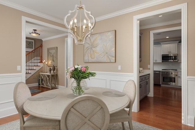 2027 Holden Farm Pl Unit 622, Ooltewah, TN 37363 - dining area featuring dark wood-style flooring, stairway, a chandelier, crown molding, and a wainscoted wall