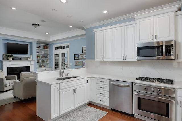 2027 Holden Farm Pl Unit 622, Ooltewah, TN 37363 - kitchen featuring stainless steel appliances, a peninsula, a sink, crown molding, and dark wood-type flooring