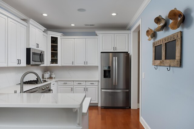 2027 Holden Farm Pl Unit 622, Ooltewah, TN 37363 - kitchen featuring stainless steel appliances, crown molding, glass insert cabinets, white cabinetry, and recessed lighting