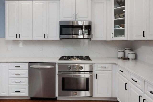 2027 Holden Farm Pl Unit 622, Ooltewah, TN 37363 - kitchen featuring stainless steel appliances, white cabinetry, and backsplash