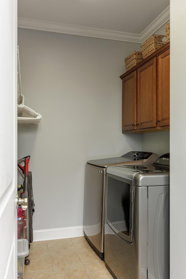 2027 Holden Farm Pl Unit 622, Ooltewah, TN 37363 - laundry area featuring cabinet space, independent washer and dryer, ornamental molding, baseboards, and light tile patterned floors