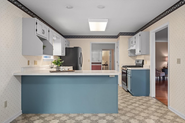 20 Debbie Ln, Ringgold, GA 30736 - kitchen featuring appliances with stainless steel finishes, light flooring, wallpapered walls, a peninsula, and light countertops