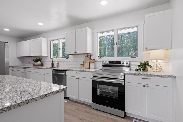 1795 Dowdy Rd, Cleveland, TN 37323 - kitchen featuring appliances with stainless steel finishes, a sink, recessed lighting, white cabinets, and tasteful backsplash