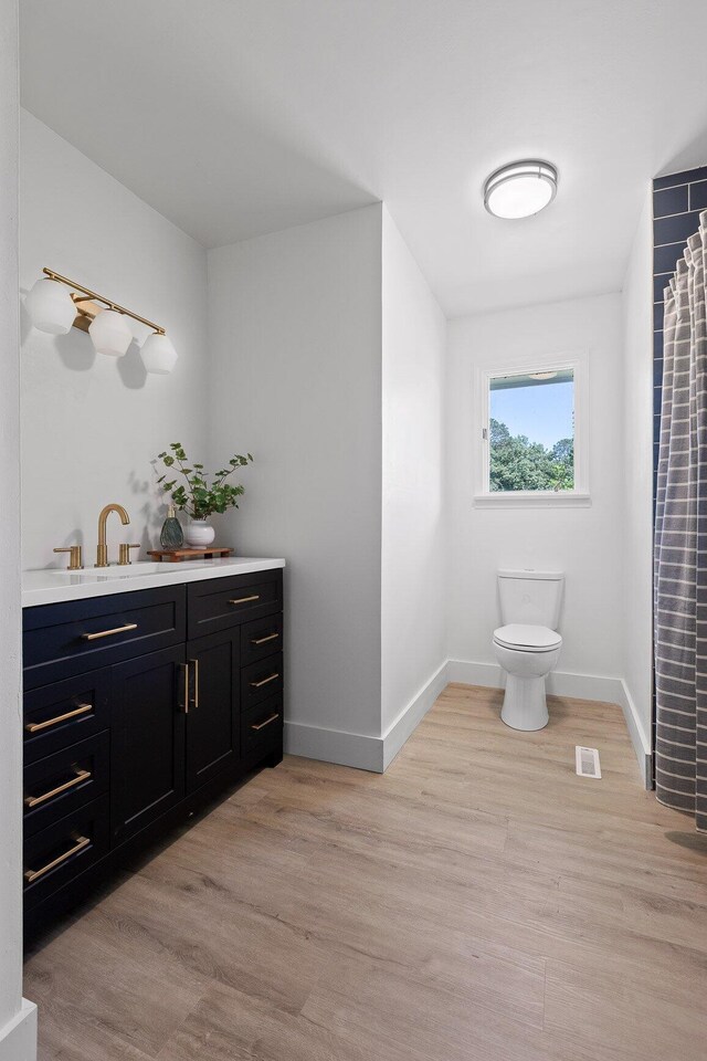 1795 Dowdy Rd, Cleveland, TN 37323 - full bath featuring toilet, vanity, baseboards, and wood finished floors