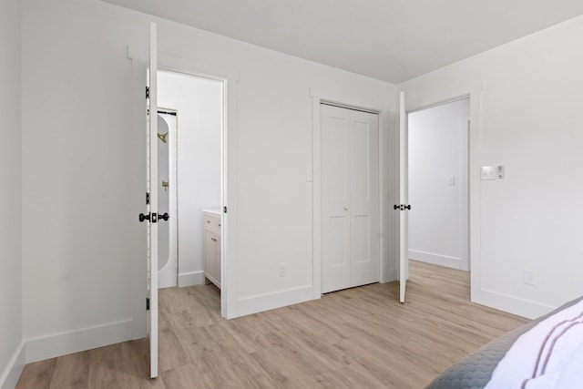 1795 Dowdy Rd, Cleveland, TN 37323 - unfurnished bedroom with light wood-type flooring, baseboards, and a closet