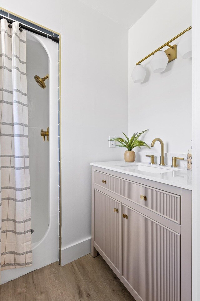 1795 Dowdy Rd, Cleveland, TN 37323 - full bath with wood finished floors, vanity, shower / bath combination with curtain, and baseboards