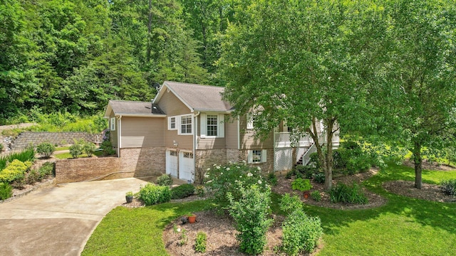 5726 Browntown Rd, Chattanooga, TN 37415 - view of front of property with concrete driveway, stairs, a garage, brick siding, and a front lawn