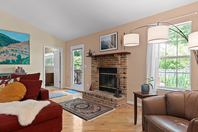 5726 Browntown Rd, Chattanooga, TN 37415 - living room with light wood-style flooring, lofted ceiling, a brick fireplace, and baseboards