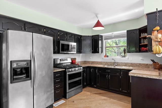 5726 Browntown Rd, Chattanooga, TN 37415 - kitchen featuring appliances with stainless steel finishes, a sink, dark cabinetry, and open shelves