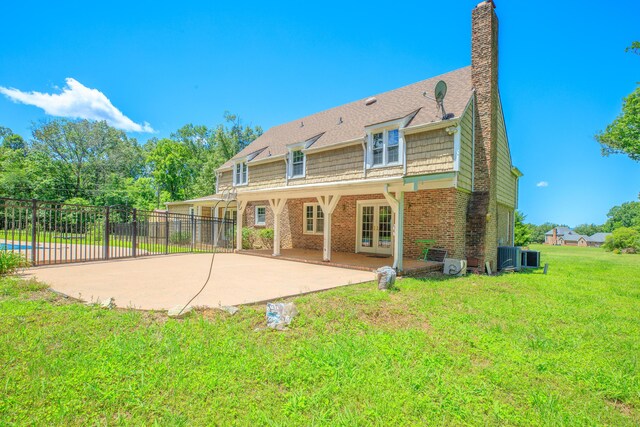 7900 Ooltewah Georgetown Rd, Ooltewah, TN 37363 - back of property featuring french doors, a patio, brick siding, a chimney, and central AC unit