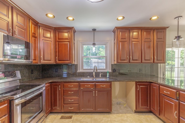 7900 Ooltewah Georgetown Rd, Ooltewah, TN 37363 - kitchen with stainless steel range with electric cooktop, a sink, black microwave, recessed lighting, and decorative light fixtures