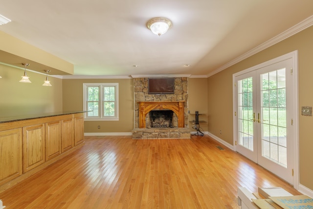 7900 Ooltewah Georgetown Rd, Ooltewah, TN 37363 - unfurnished living room featuring light wood-style floors, crown molding, french doors, baseboards, and a stone fireplace