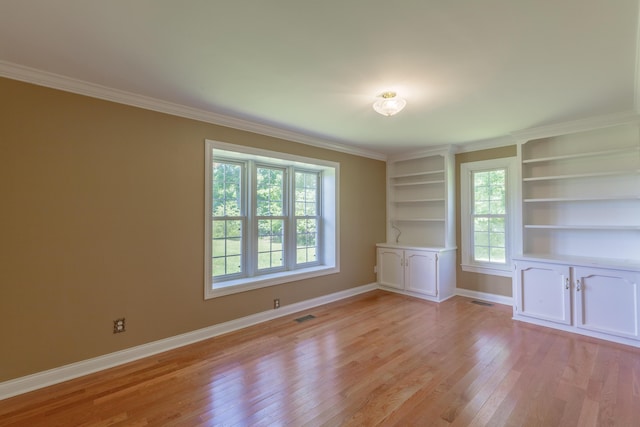 7900 Ooltewah Georgetown Rd, Ooltewah, TN 37363 - empty room with light wood-style floors, baseboards, ornamental molding, and built in features